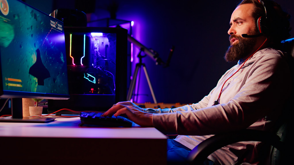 man-neon-lit-apartment-playing-singleplayer-videogame.jpg